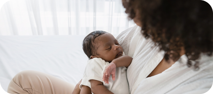 Black mother holds newborn baby.