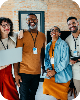 A diverse team smiles for a photo.